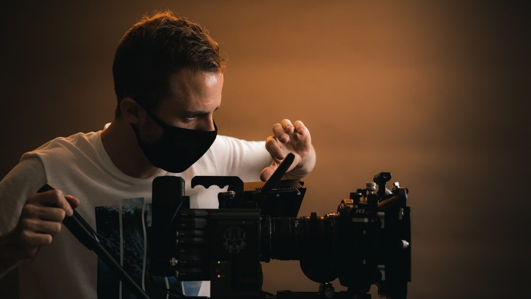 Camera operator adjusting a professional video camera