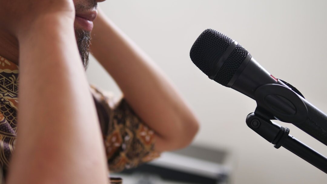 Person reading a news script into a microphone
